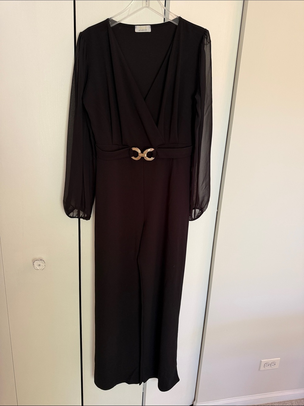 Elegant Black Long-Sleeve Jumpsuit with Gold Buckle